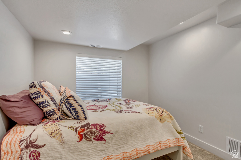 Carpeted bedroom with baseboards and recessed lighting