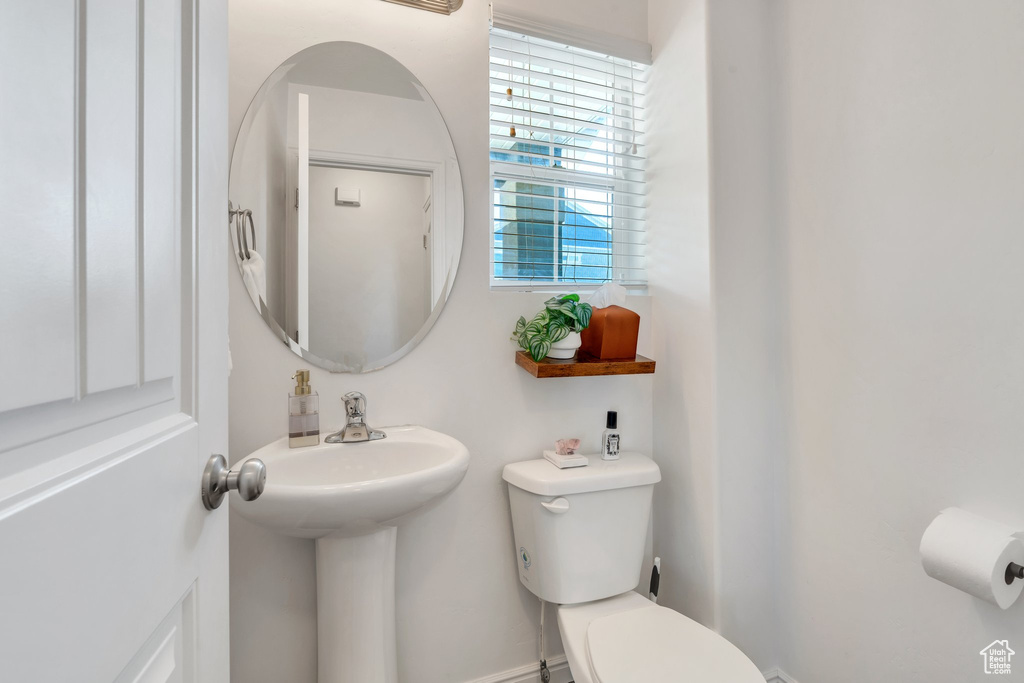 Half bathroom with toilet and a sink