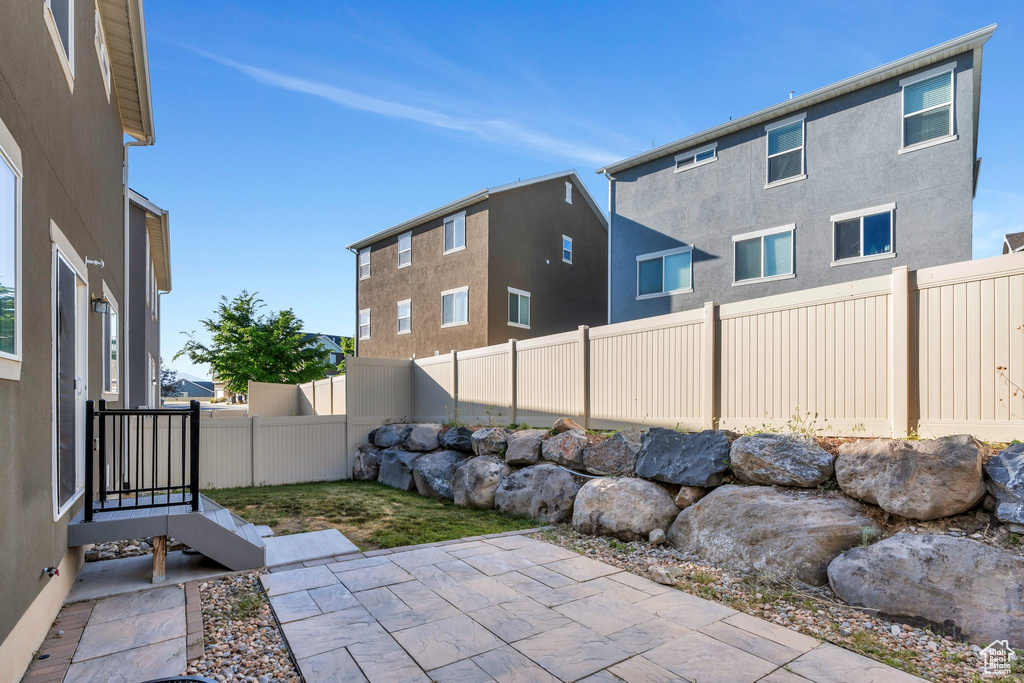 Fenced backyard featuring a patio