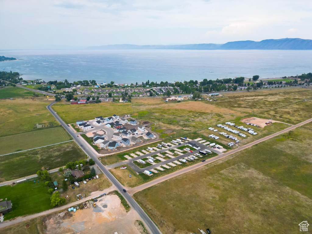 Aerial view of property and surrounding area featuring a water and mountain view