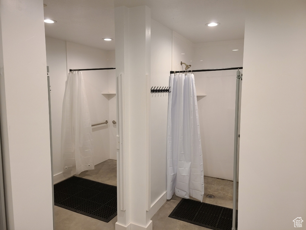 Full bathroom with a shower with shower curtain, recessed lighting, and concrete flooring