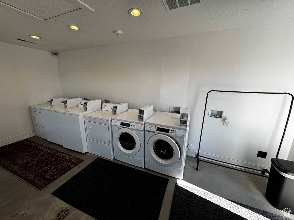 Shared laundry featuring washing machine and dryer, recessed lighting, and baseboards