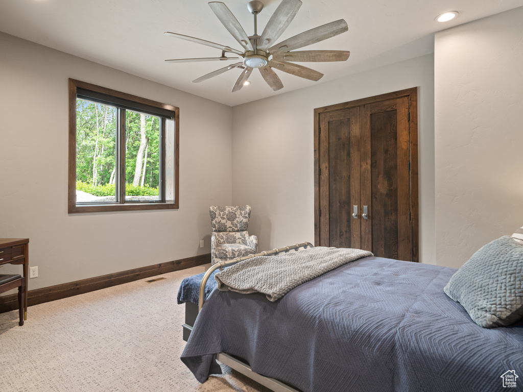 Carpeted bedroom with baseboards, recessed lighting, and a ceiling fan