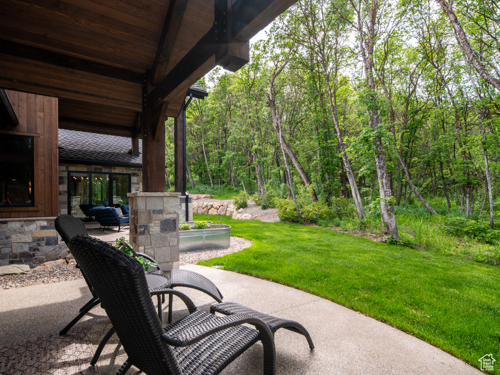View of patio featuring a forest view