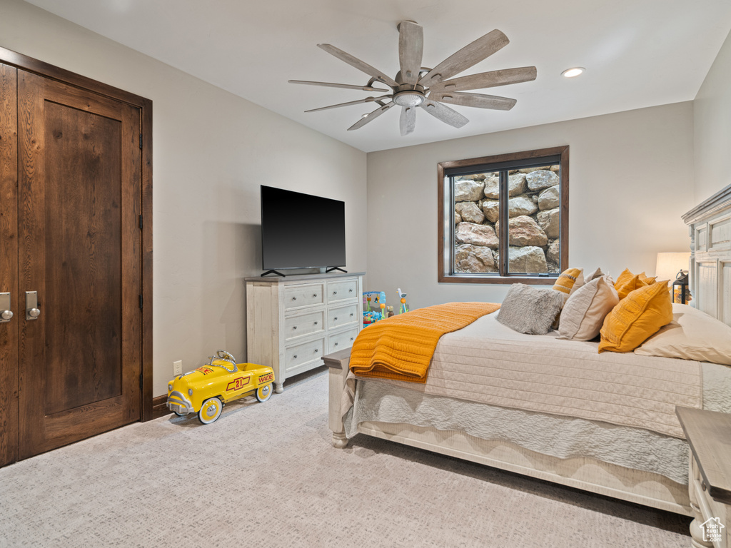 Carpeted bedroom with recessed lighting and ceiling fan