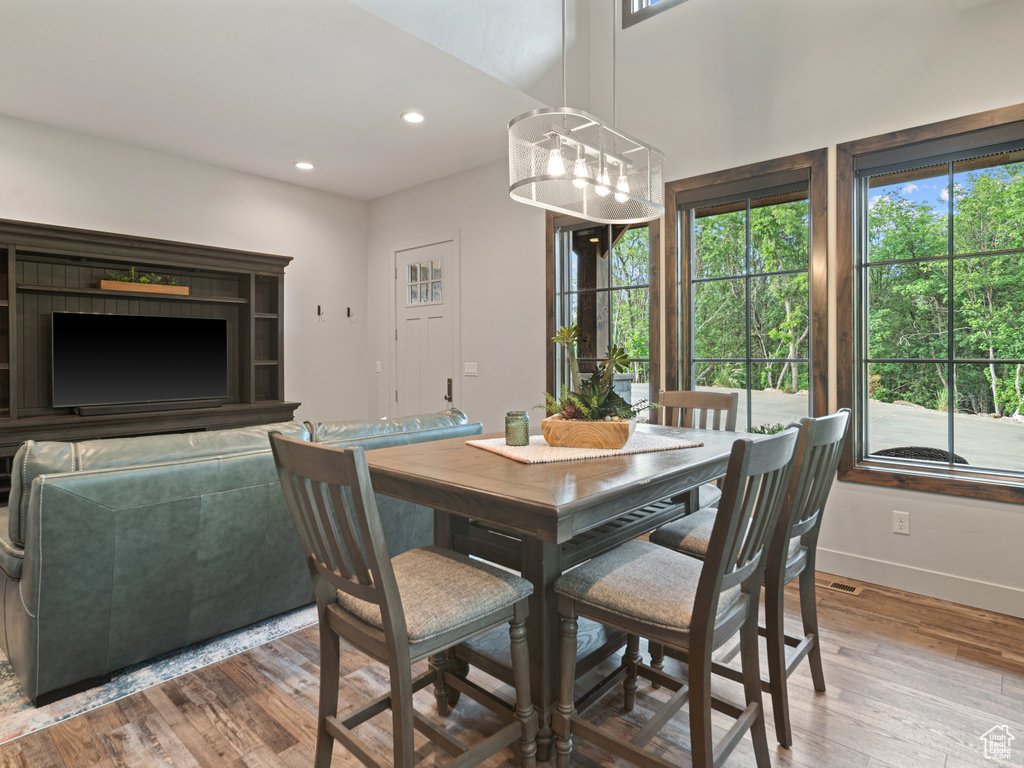 Dining space with plenty of natural light, hardwood / wood-style floors, baseboards, and recessed lighting