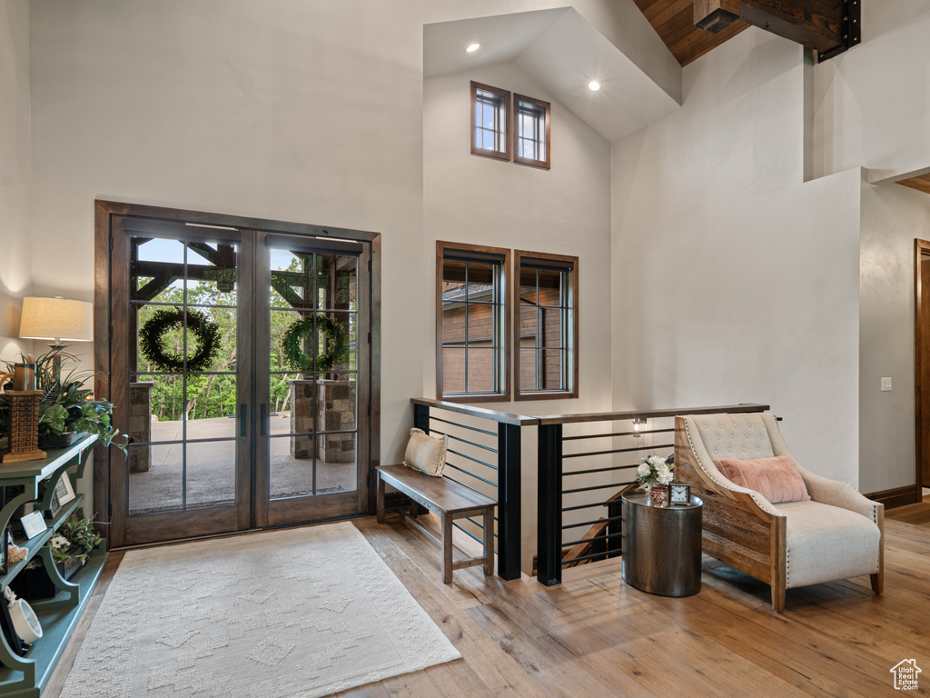 Entryway with high vaulted ceiling, french doors, hardwood / wood-style floors, recessed lighting, and beam ceiling
