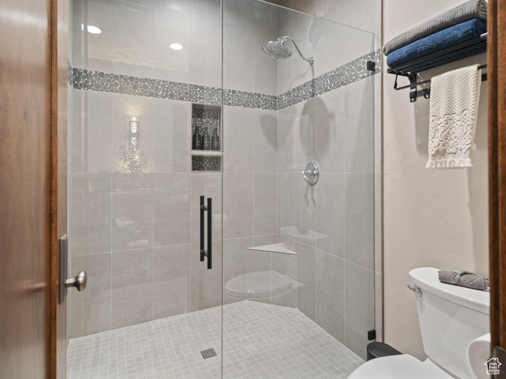 Bathroom featuring toilet and a stall shower