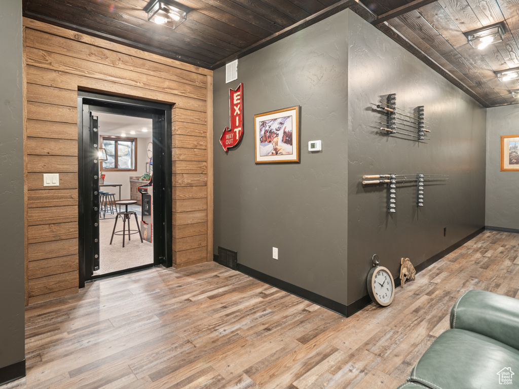 Hall featuring wood ceiling, wood finished floors, and baseboards