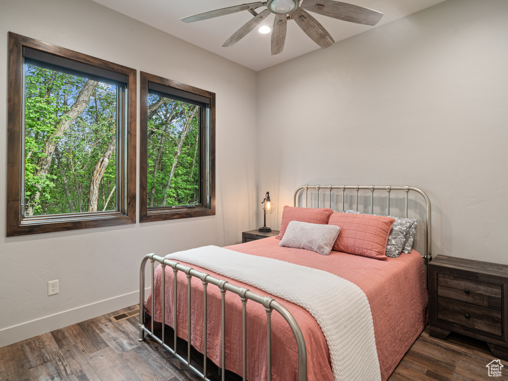 Bedroom with wood finished floors, baseboards, and a ceiling fan