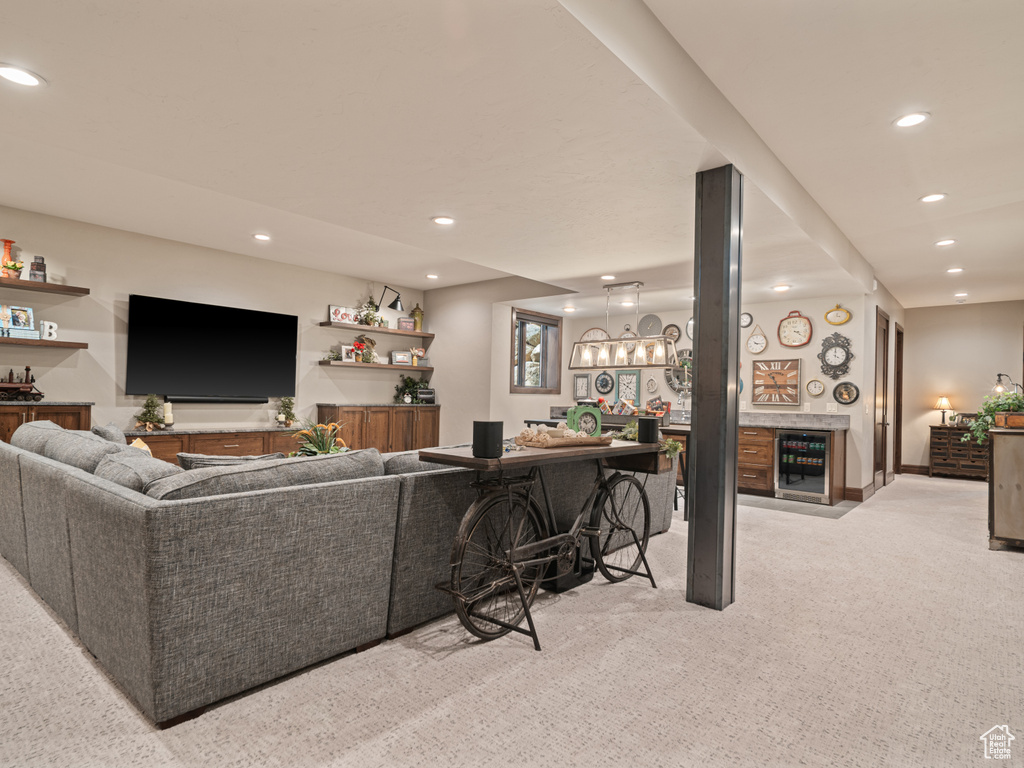Living area featuring bar area, recessed lighting, and light carpet