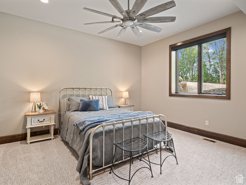Carpeted bedroom with baseboards, ceiling fan, and recessed lighting