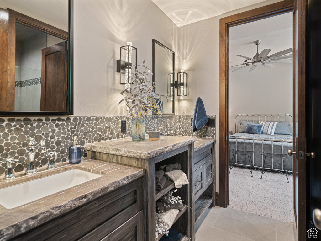 Bathroom featuring decorative backsplash, vanity, connected bathroom, and a ceiling fan