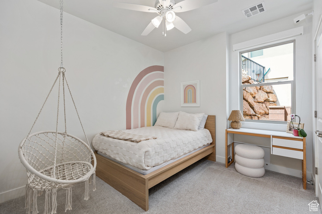 Bedroom with carpet, baseboards, and ceiling fan