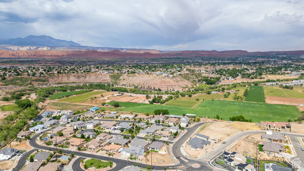 Aerial view of property's location featuring a mountain backdrop and nearby suburban area