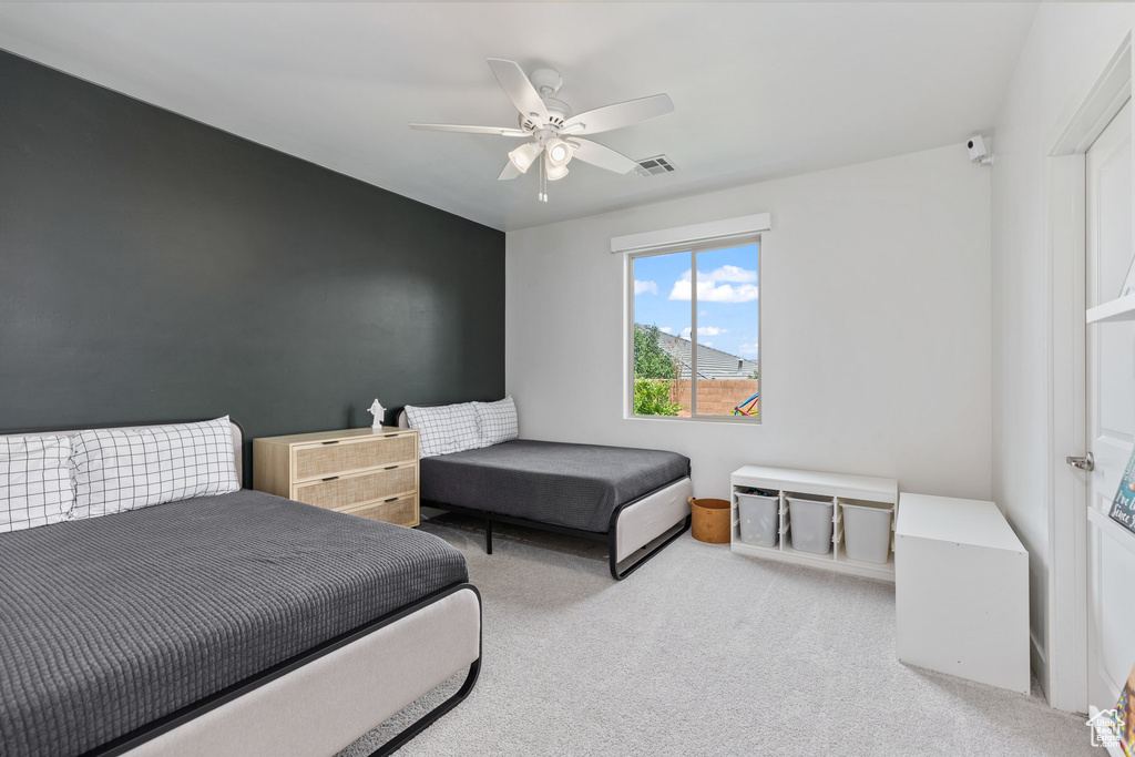 Bedroom with carpet flooring and a ceiling fan