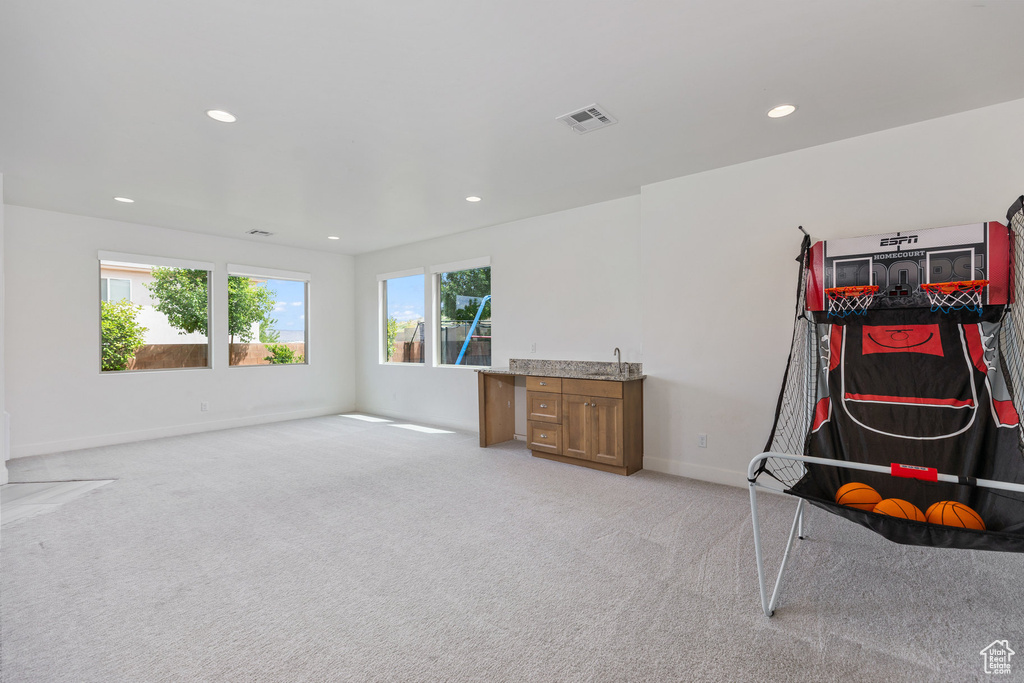 Game room featuring recessed lighting, light colored carpet, and baseboards