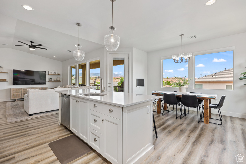 Kitchen featuring a sink, dishwasher, plenty of natural light, recessed lighting, and light countertops