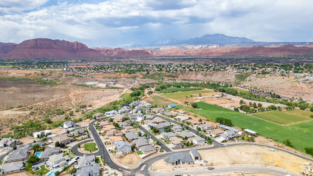 Aerial overview of property's location featuring mountains, nearby suburban area, and rural landscape