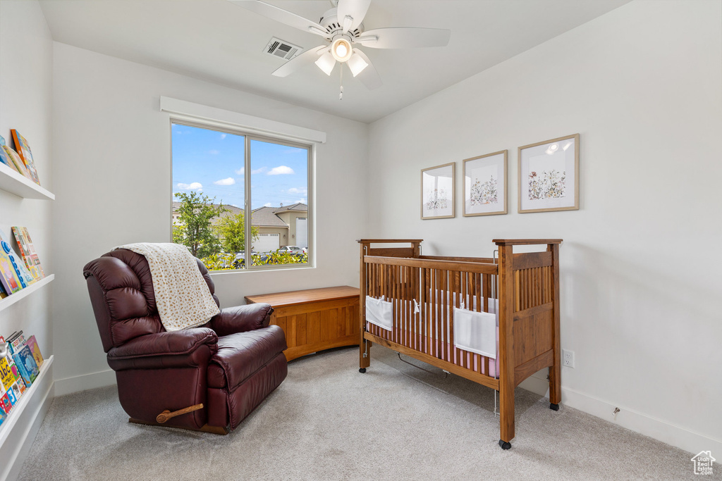 Bedroom with light carpet, baseboards, and ceiling fan