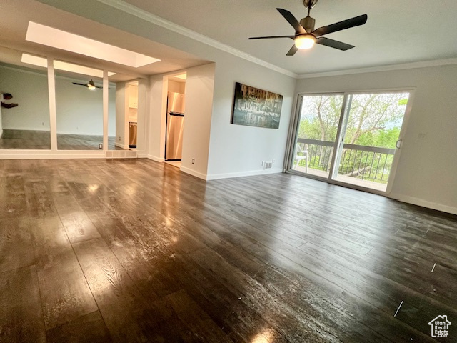 Unfurnished living room with ceiling fan, dark wood-style flooring, baseboards, and crown molding