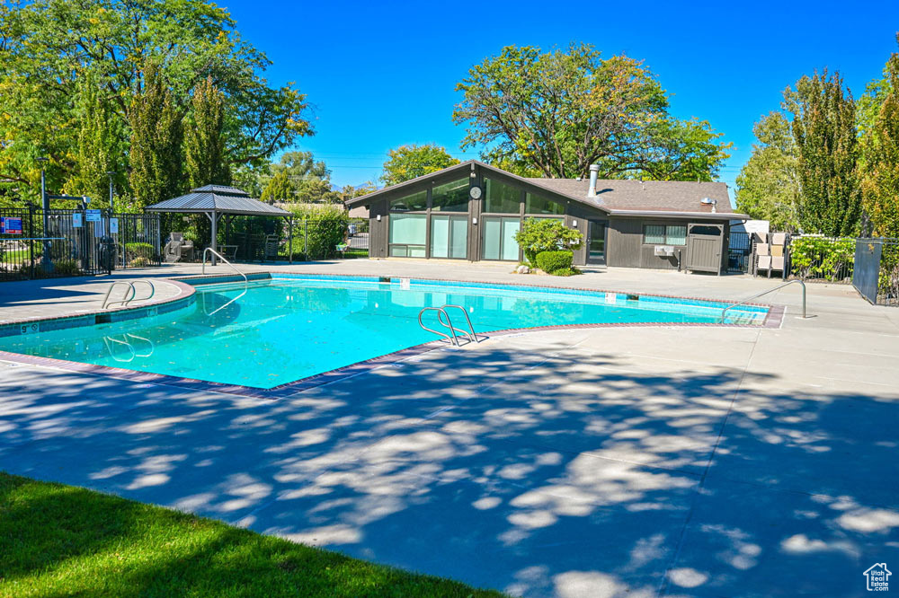 Community pool featuring a patio and a gazebo