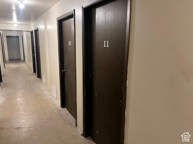 Hall featuring unfinished concrete flooring