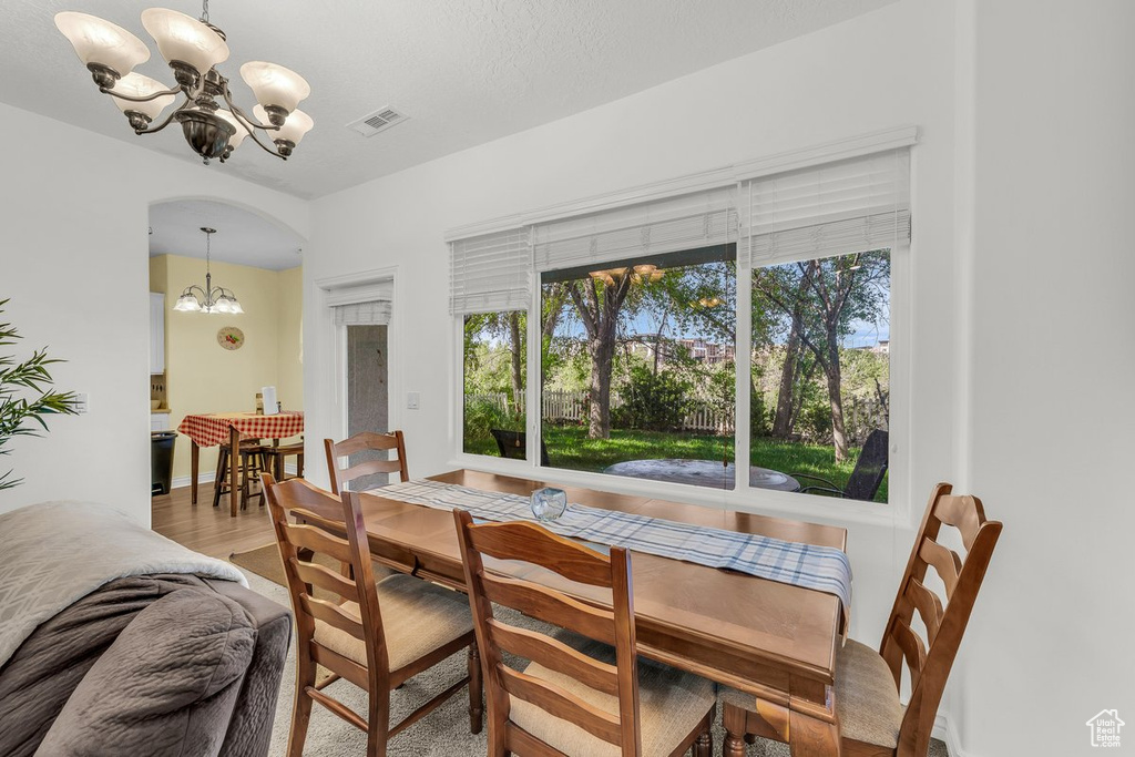 Dining room with a chandelier and wood finished floors