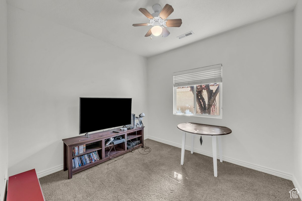 Sitting room with carpet floors, ceiling fan, and baseboards