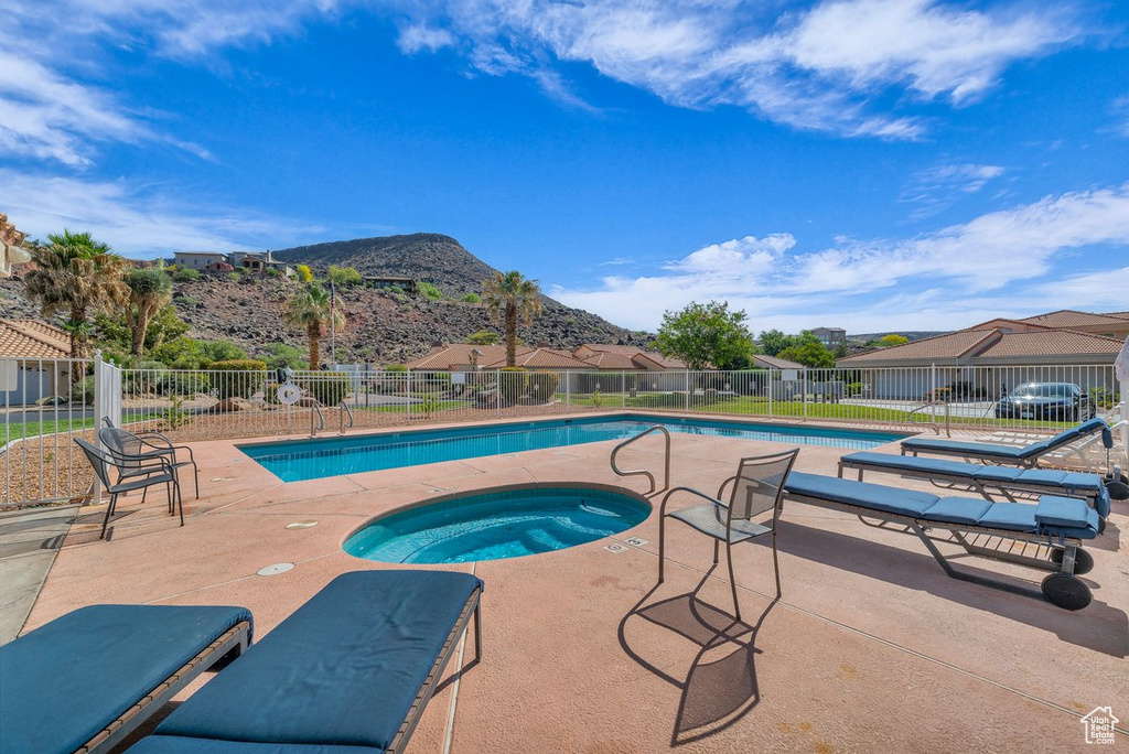 Community pool with a community hot tub, a patio area, and a mountain view