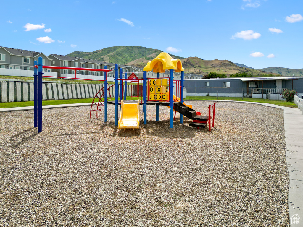 Community playground featuring a mountain view and a residential view