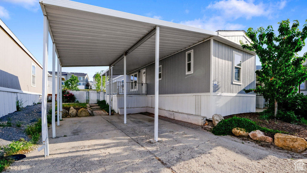 View of parking / parking lot with a carport