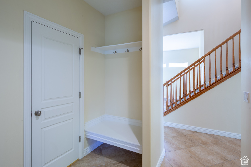 Mudroom featuring tile patterned floors and baseboards