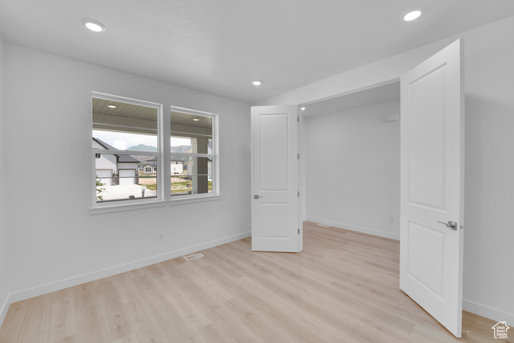Unfurnished bedroom featuring light wood-type flooring, recessed lighting, and baseboards