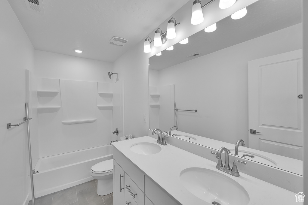 Full bathroom with double vanity, shower / tub combination, toilet, tile patterned flooring, and recessed lighting