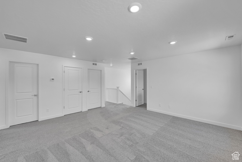 Basement featuring carpet floors, recessed lighting, and baseboards