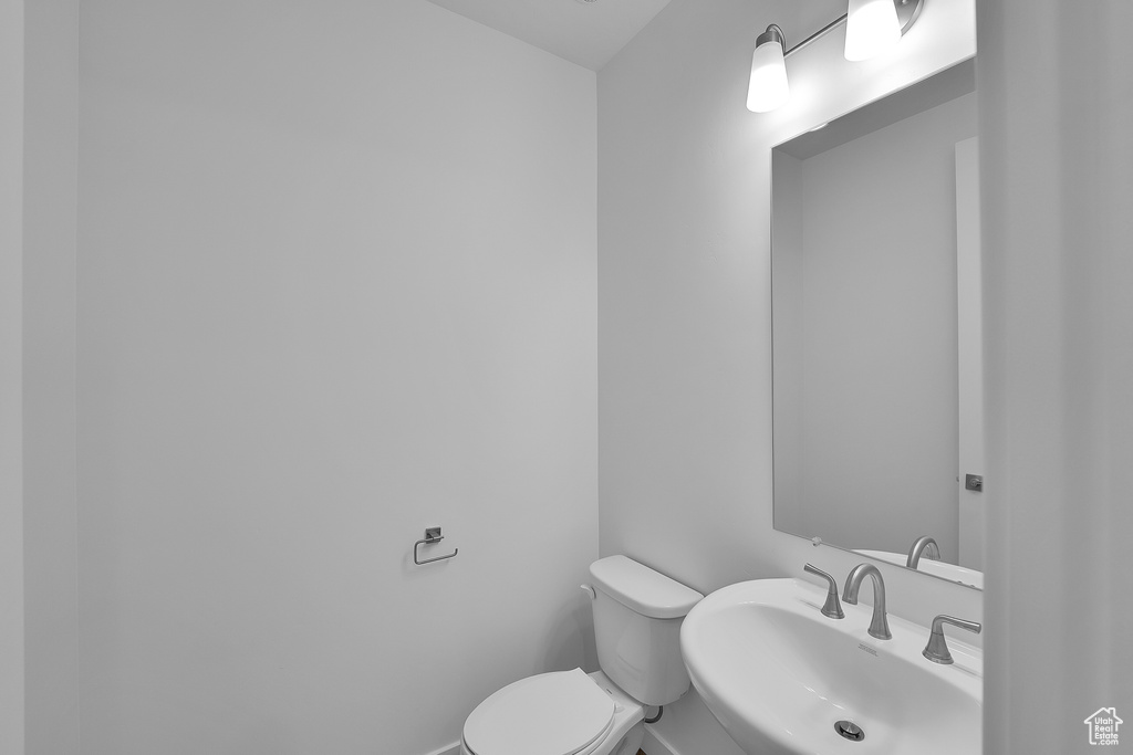 Half bath with a sink and toilet