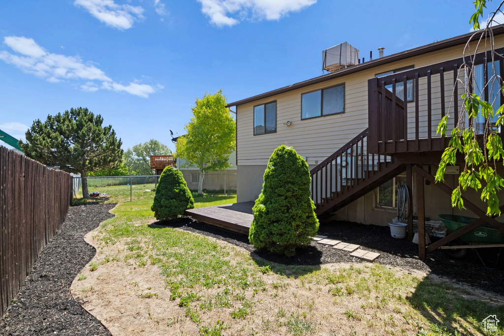 Fenced backyard with a wooden deck and stairway
