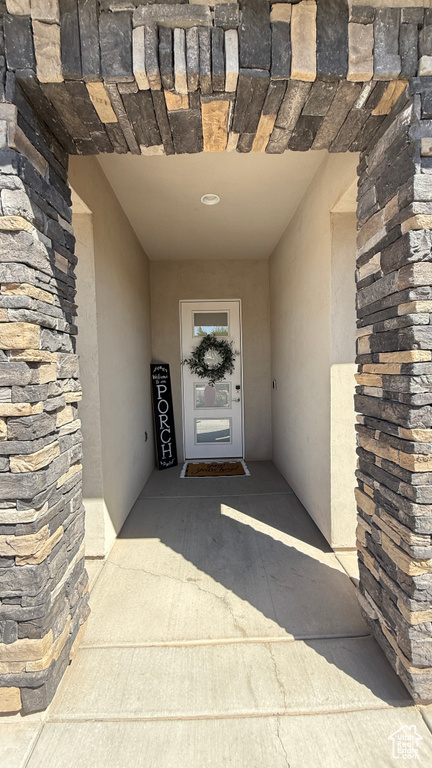 Doorway to property with stone siding