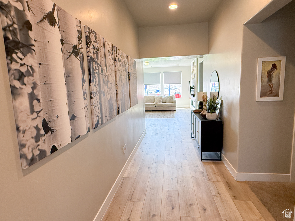 Corridor featuring light wood-type flooring and recessed lighting
