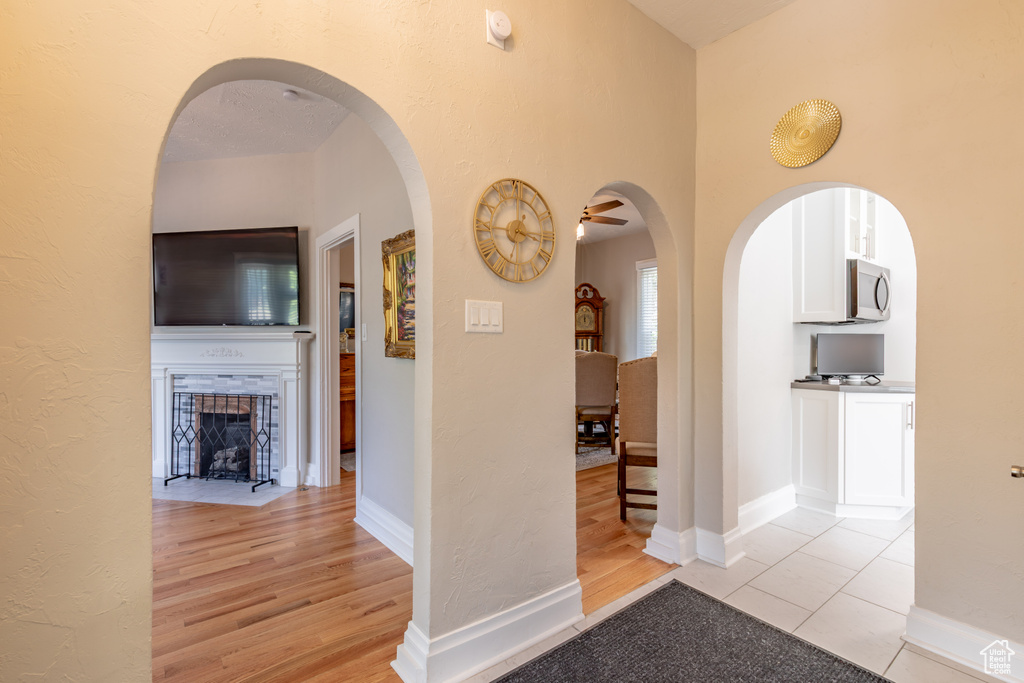 Hall featuring light wood-style flooring and baseboards