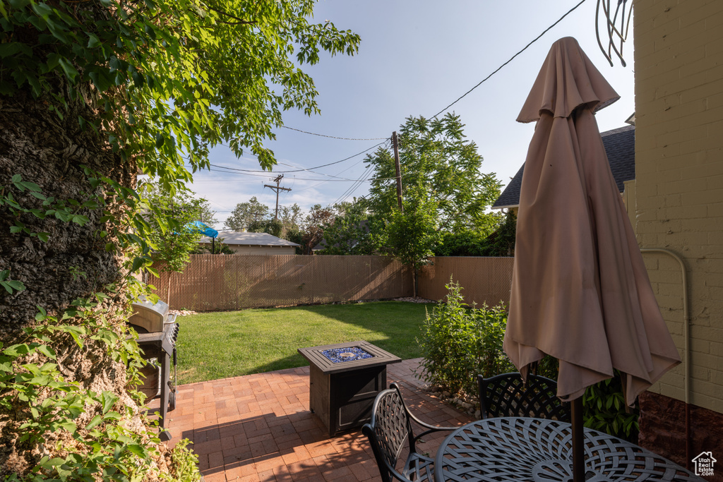 View of yard with a patio and an outdoor fire pit