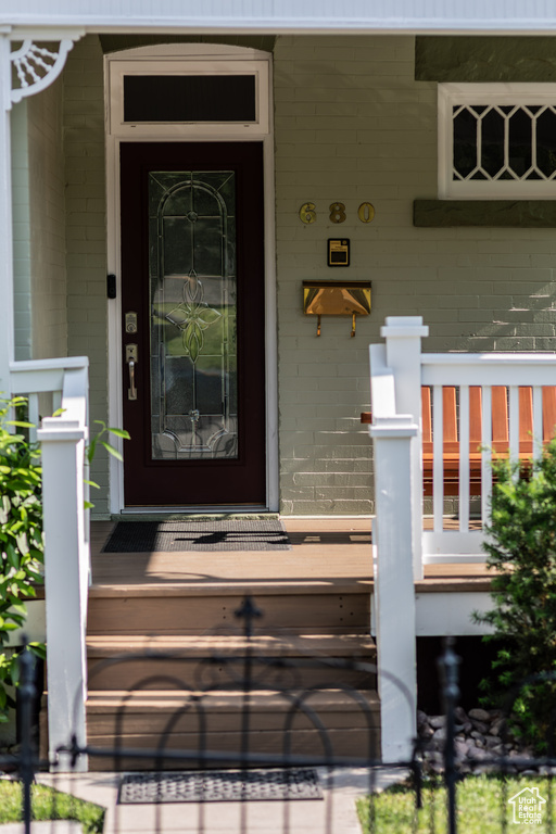 Property entrance with a porch and concrete block siding