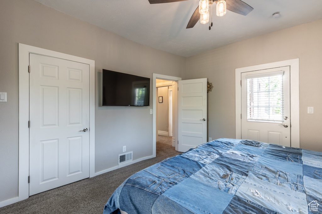 Bedroom with carpet flooring, a ceiling fan, and baseboards