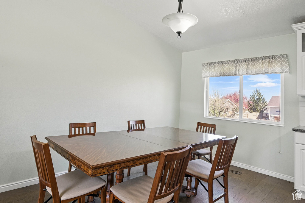Dining room with baseboards and dark wood finished floors