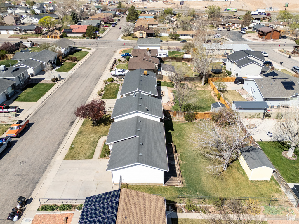 Aerial view of property and surrounding area featuring nearby suburban area