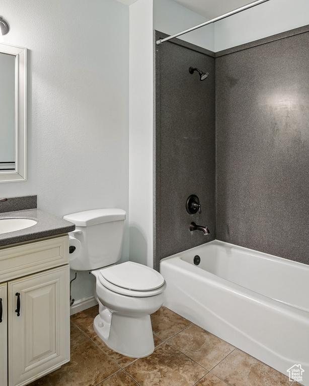 Full bathroom with vanity, toilet, tile patterned floors, and shower / bath combination