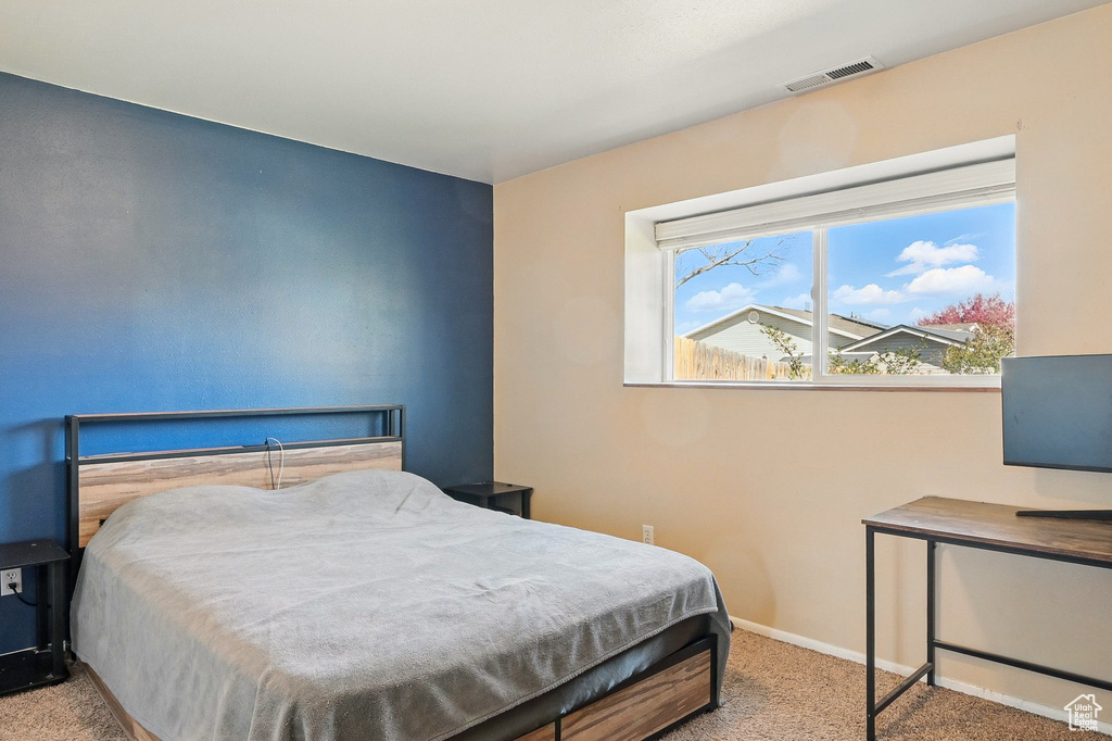 Bedroom with carpet flooring and baseboards
