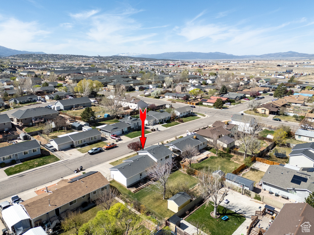 Aerial view of property's location featuring nearby suburban area and a mountainous background