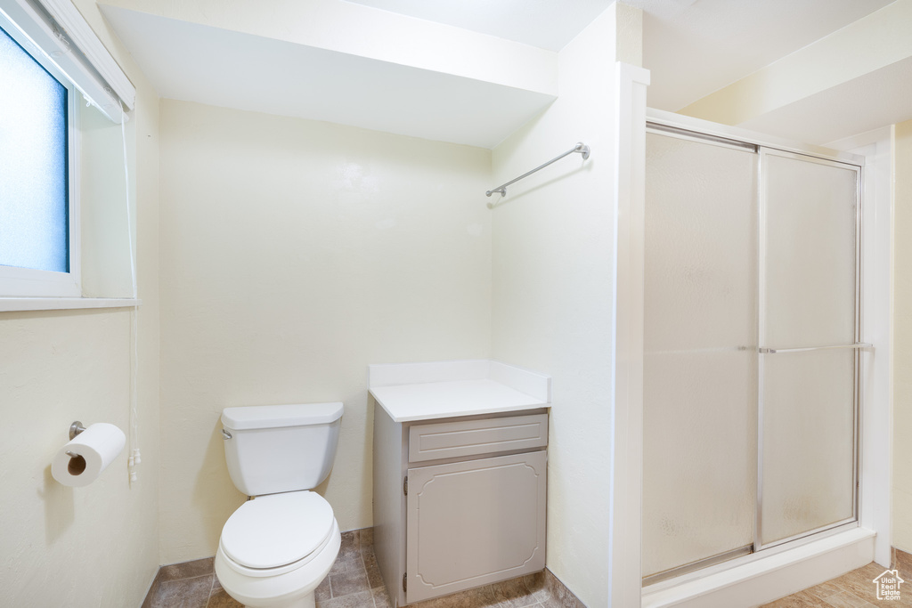 Bathroom with a shower stall and toilet